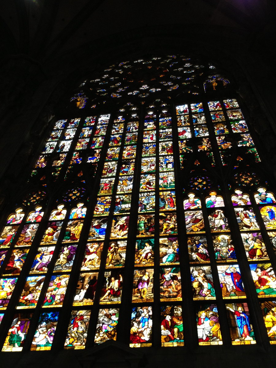 a very large and colorful window inside a cathedral
