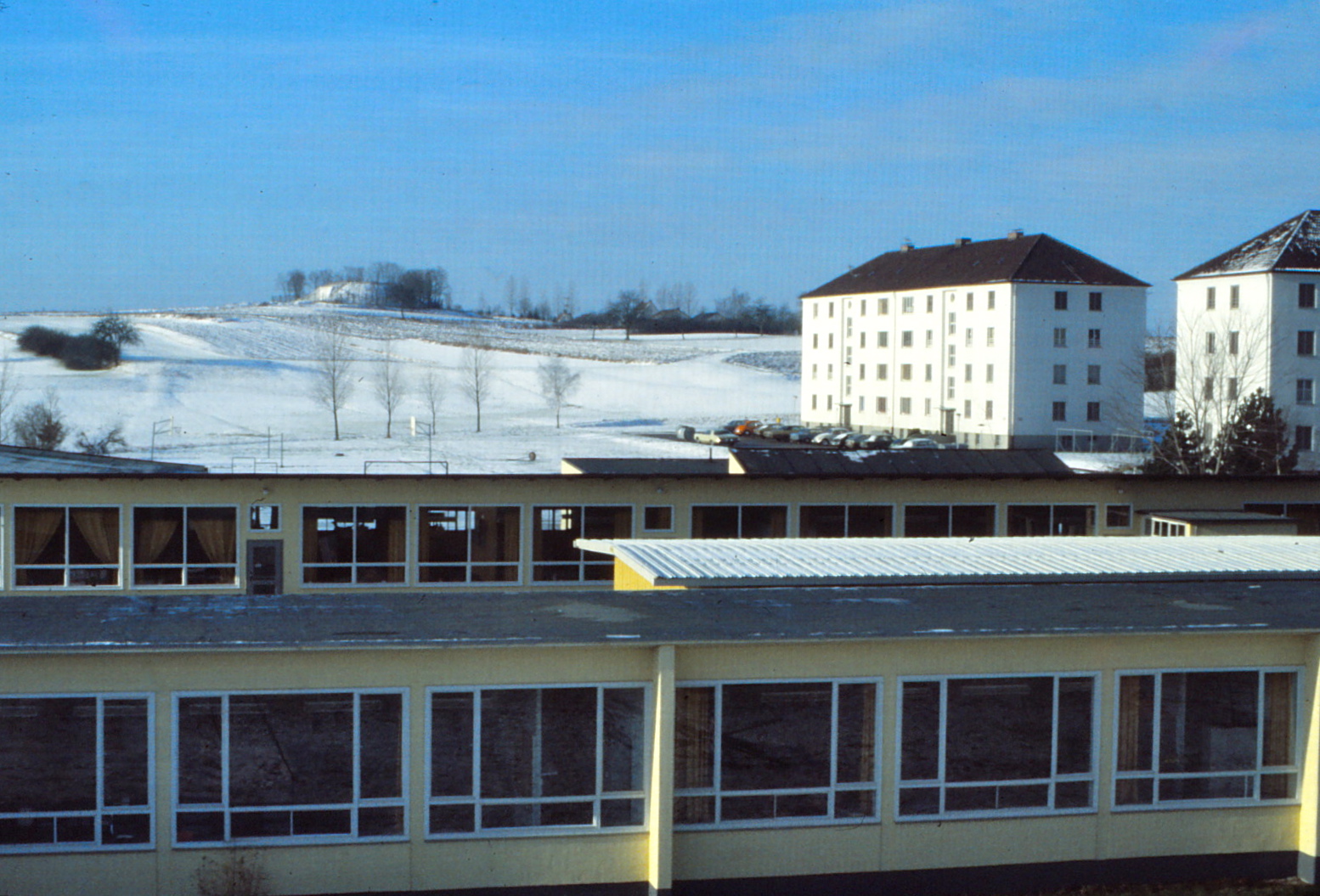 view of a building on the horizon and snow covered ground