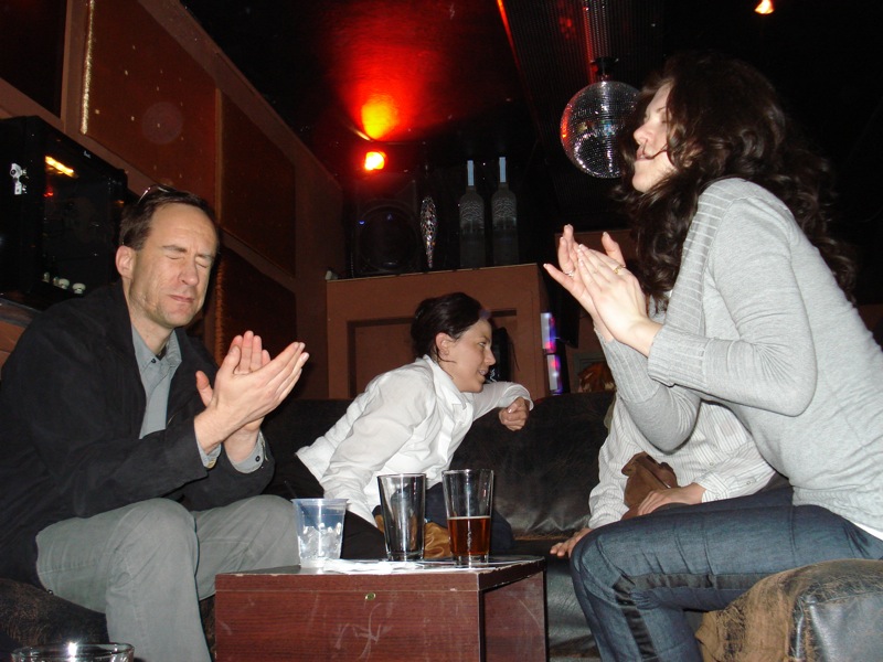 two people on the sofa clapping together