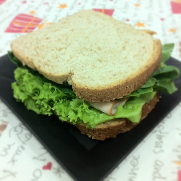 a large sandwich is shown on a black plate