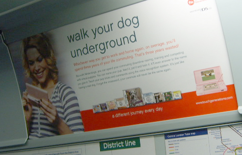 a sign on a bus that has a lady holding a tablet