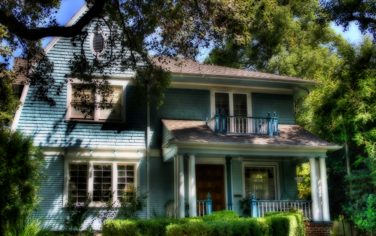 a house with a large front porch and a covered patio