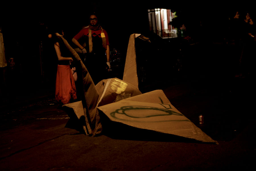 some people stand next to a canoe at night