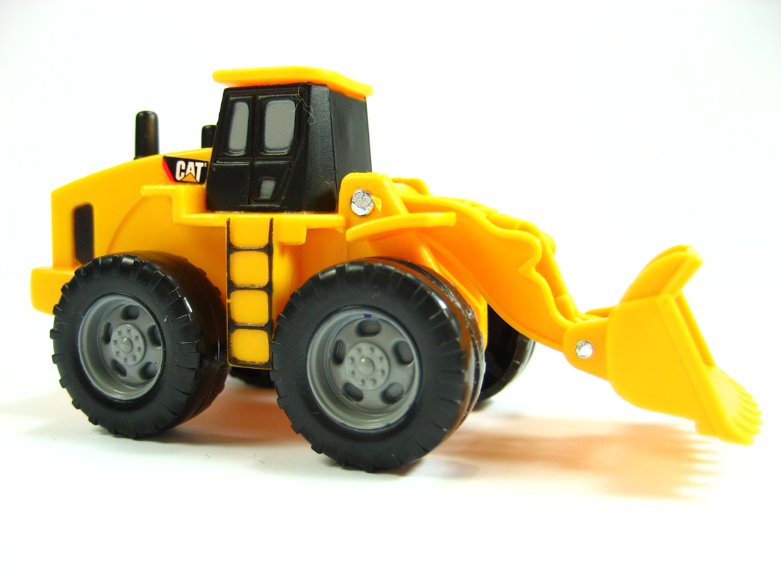 a yellow truck with black wheels and no tires