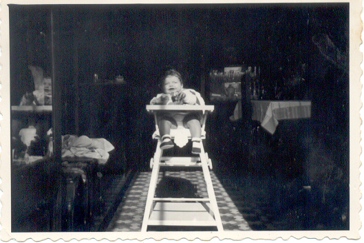 a baby in a high chair inside an old building