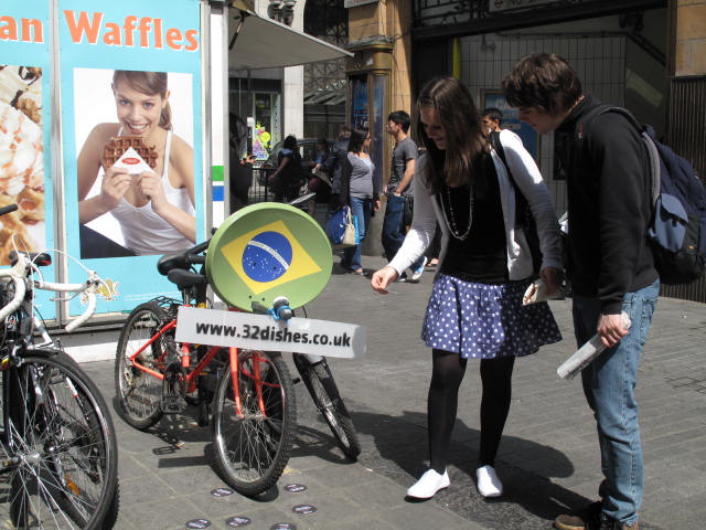 a young couple viewing the display of bicycles in an outdoor market