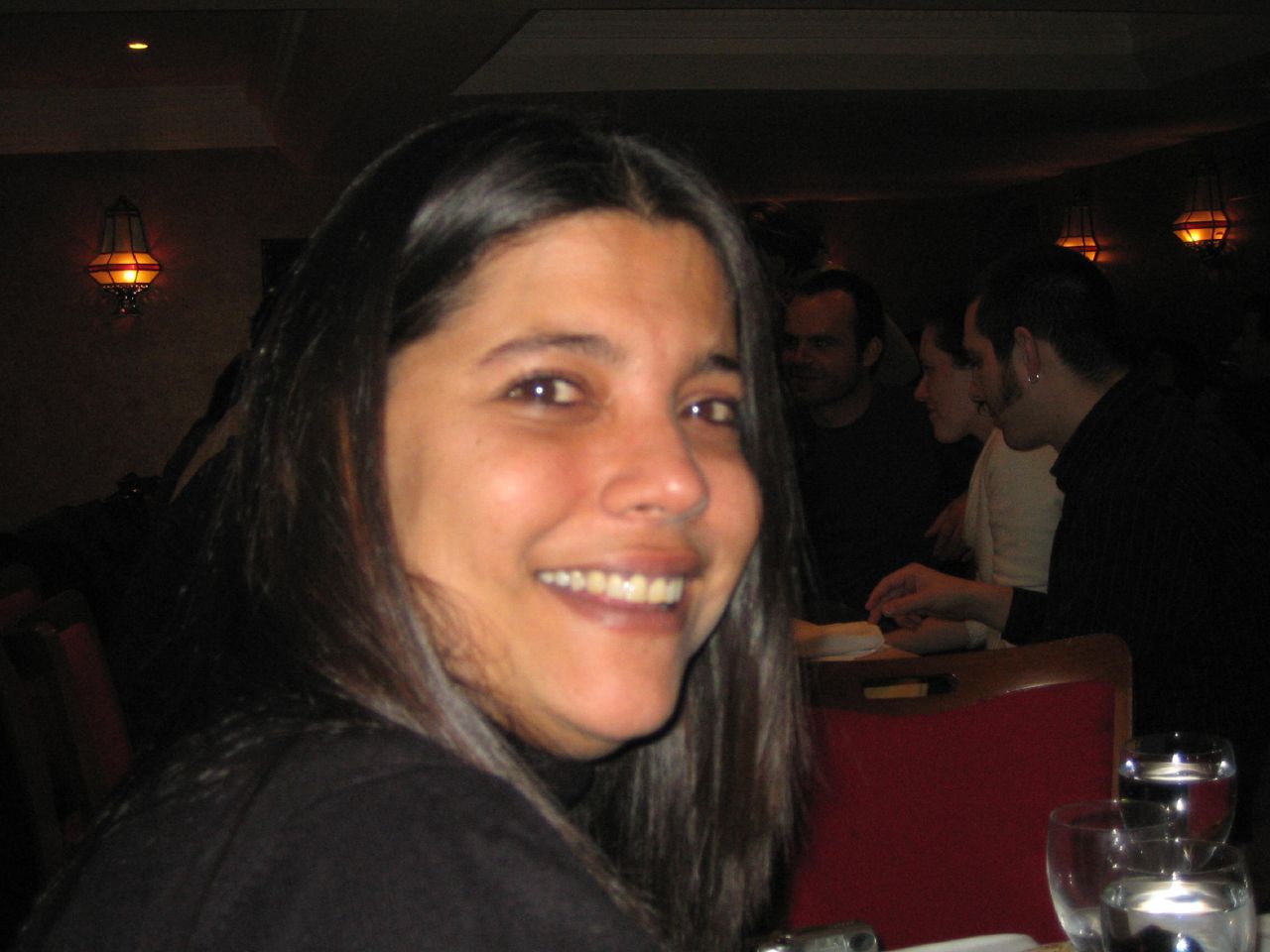 a woman with dark hair smiles for the camera