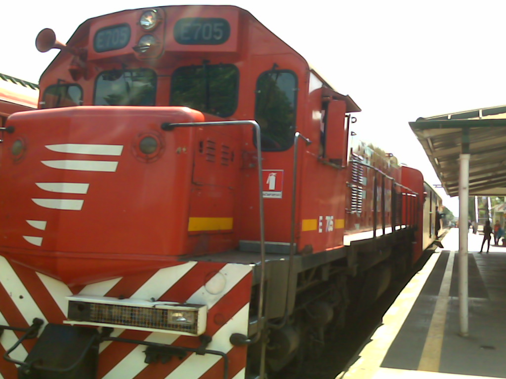 a train on the tracks next to a loading platform