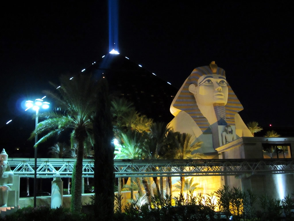 some very big statues outside in front of a building