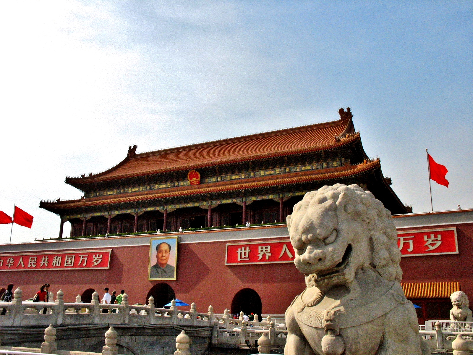 stone lion statue standing in front of a building