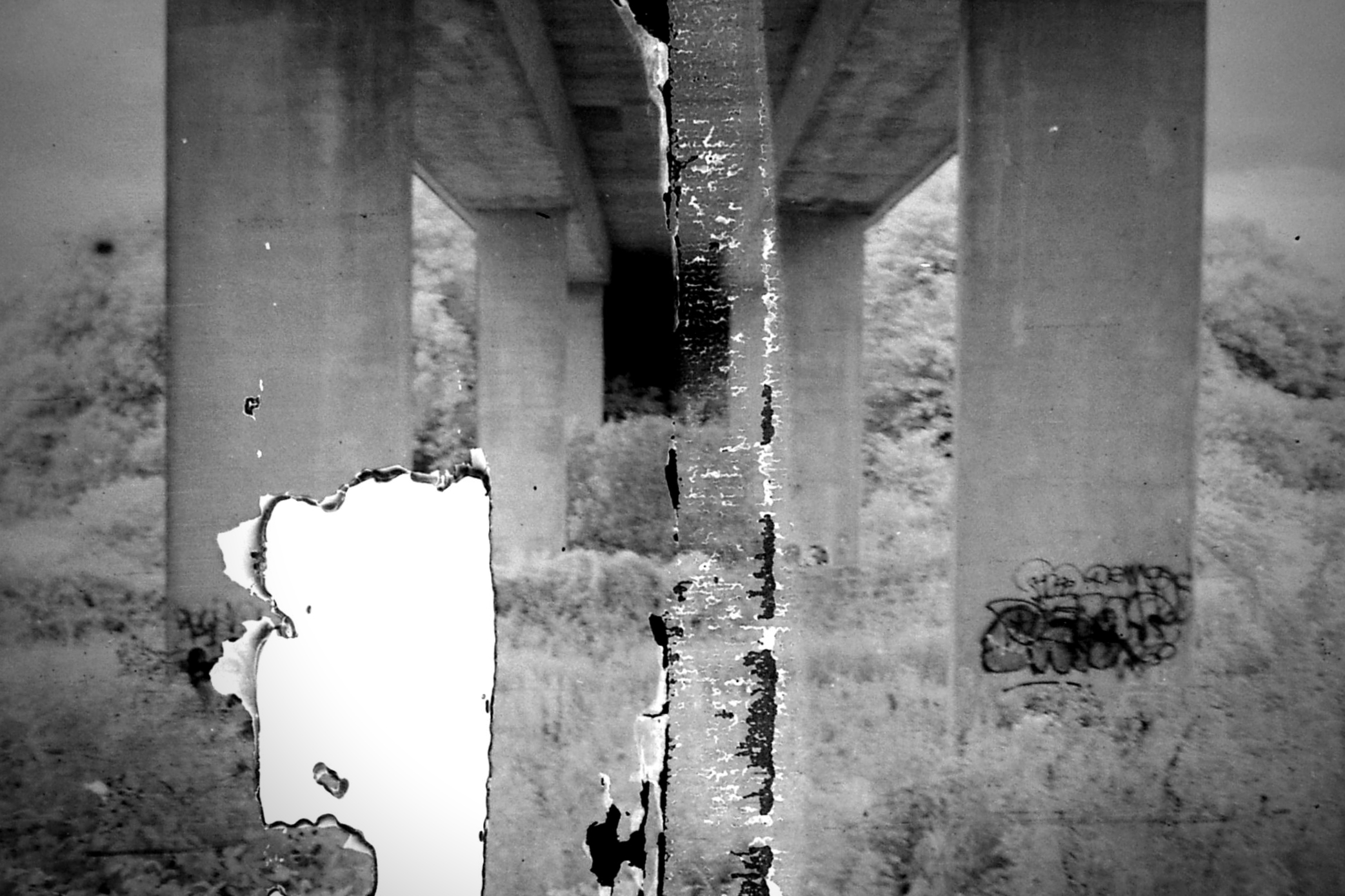 a black and white po of a concrete bridge