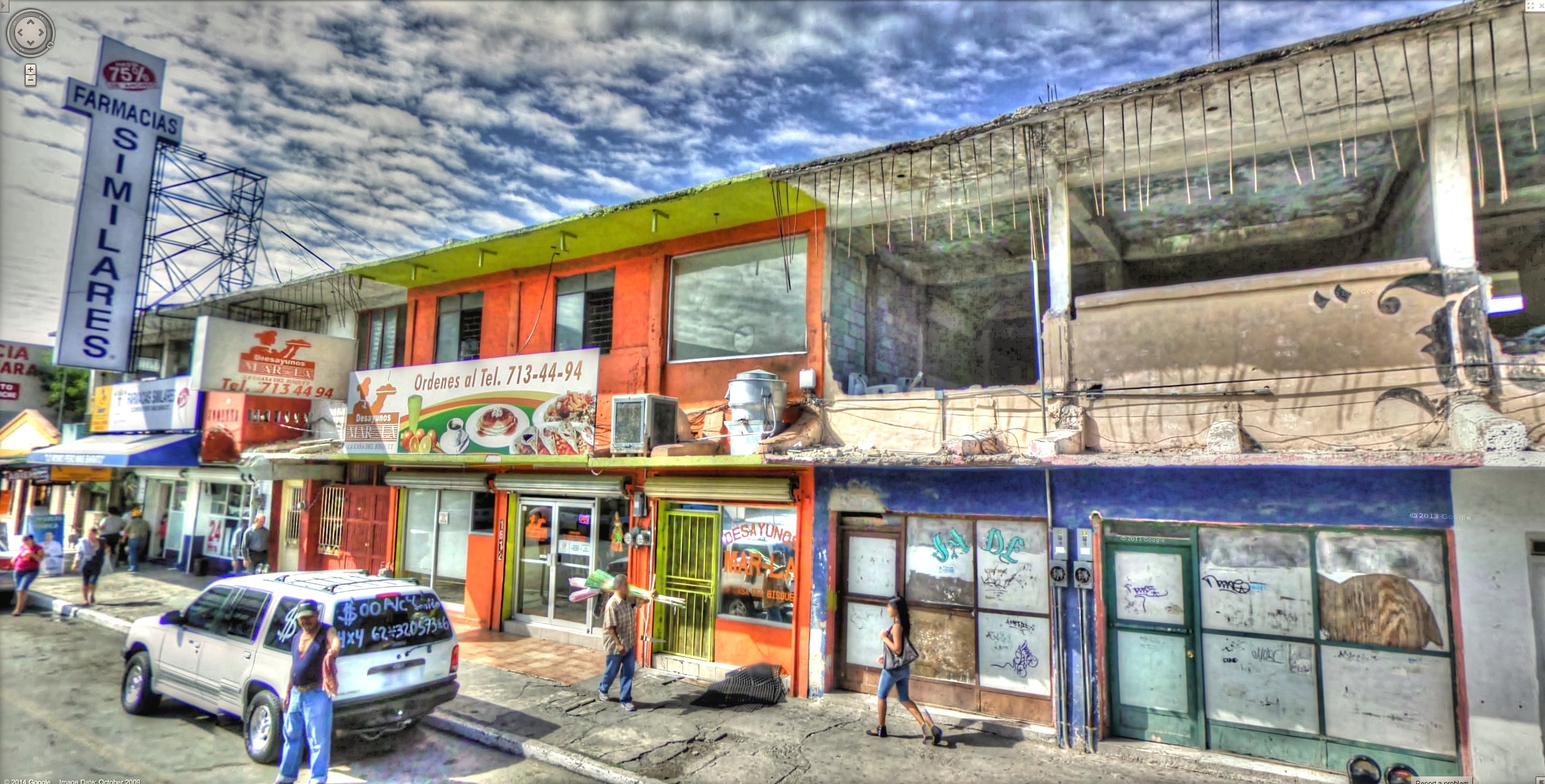 the corner of a street near stores and people