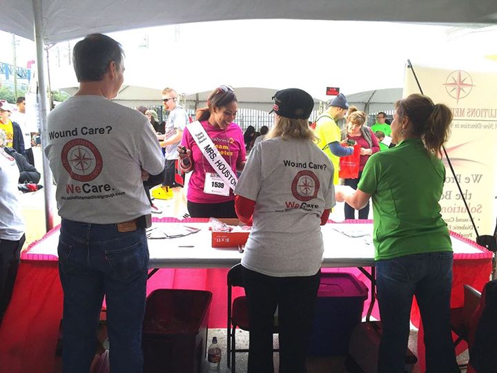 a group of people standing in front of a table at a fair