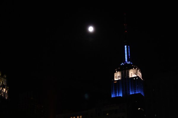 a tall building with a clock and sky in the background