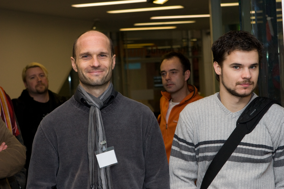 several men in the hallway of an office building