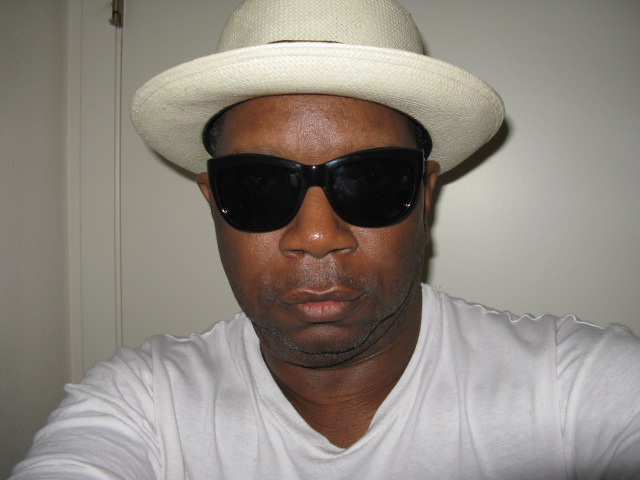a person with a hat and shades on his head