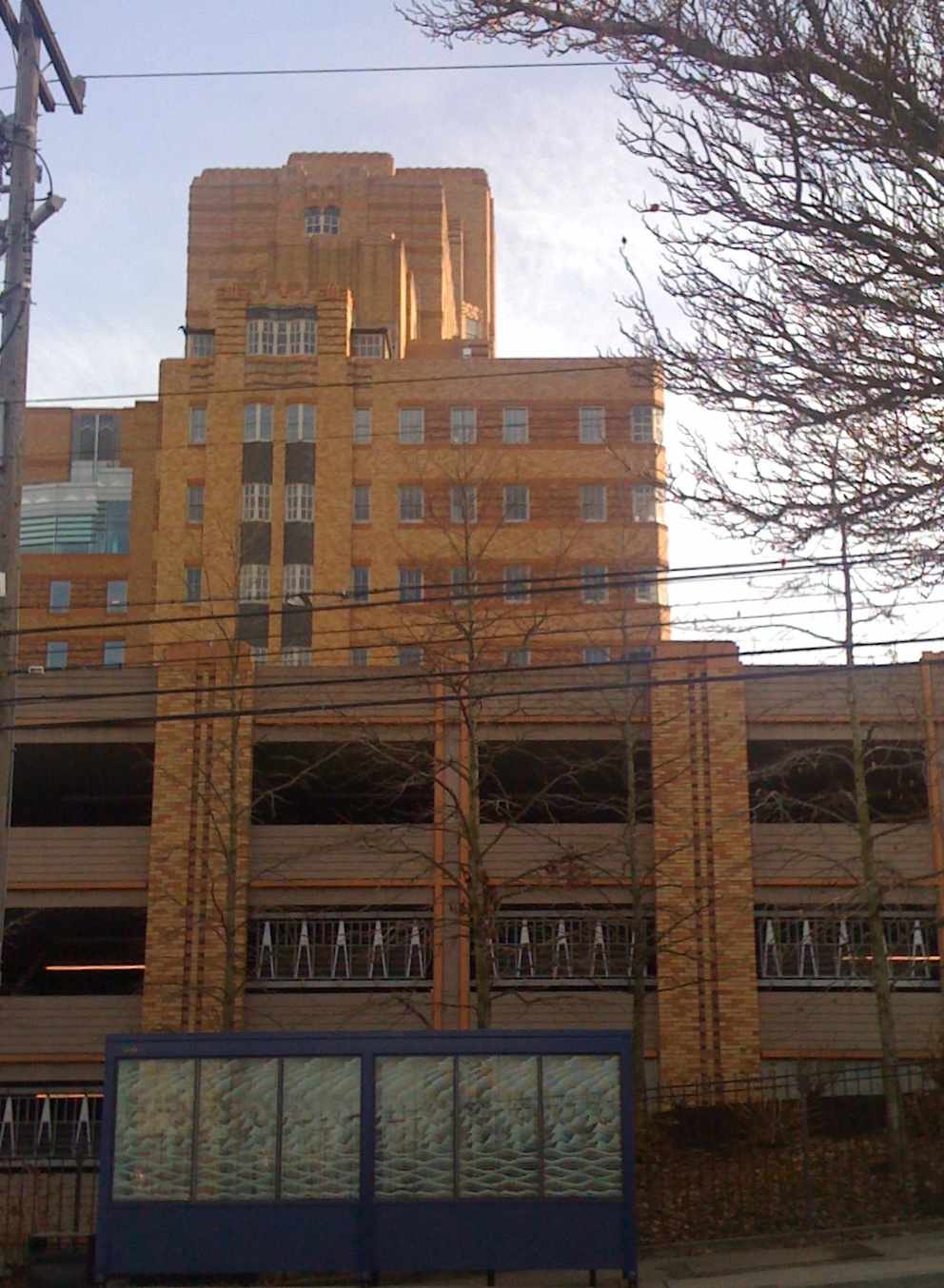 an old building with windows sitting behind some power lines