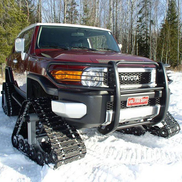 a toyota pickup on a track that has some snowplows