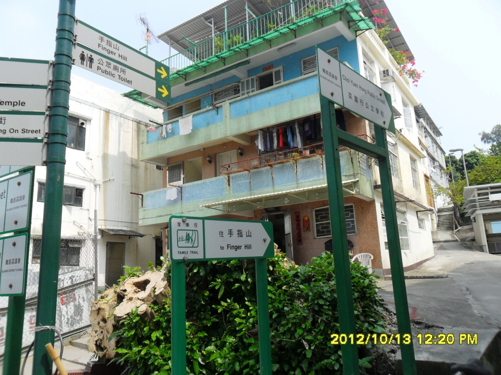 a group of street signs and some buildings