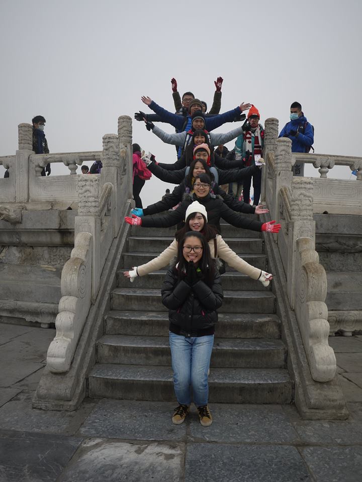 group of people posing on the same steps