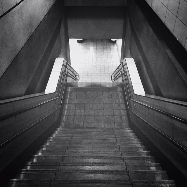 black and white po of stairs in a tunnel