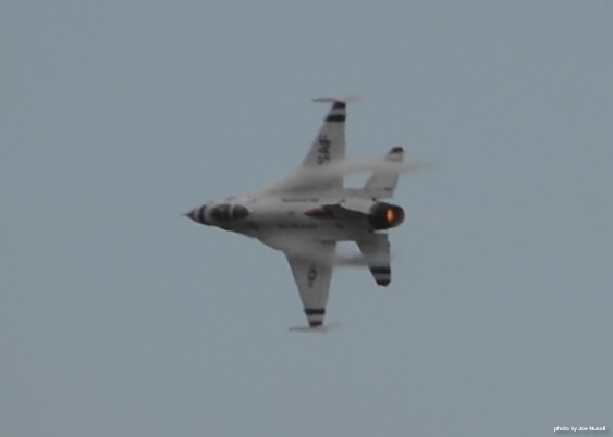 a gray fighter jet flies through the air