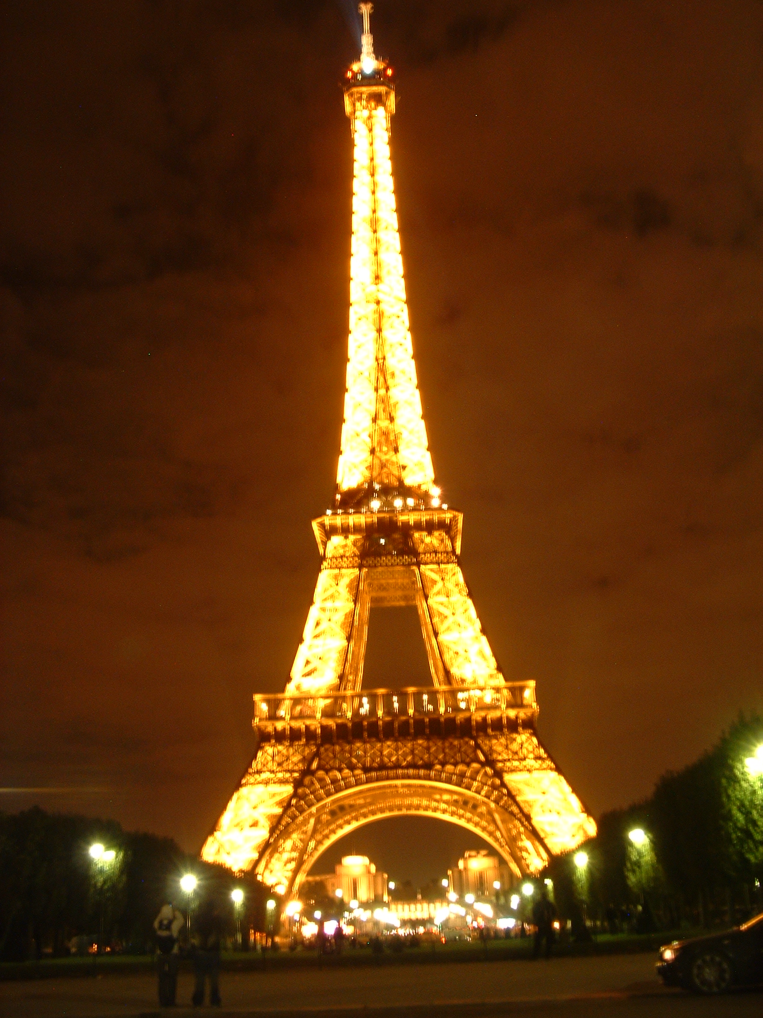 the eiffel tower is lit up in yellow light
