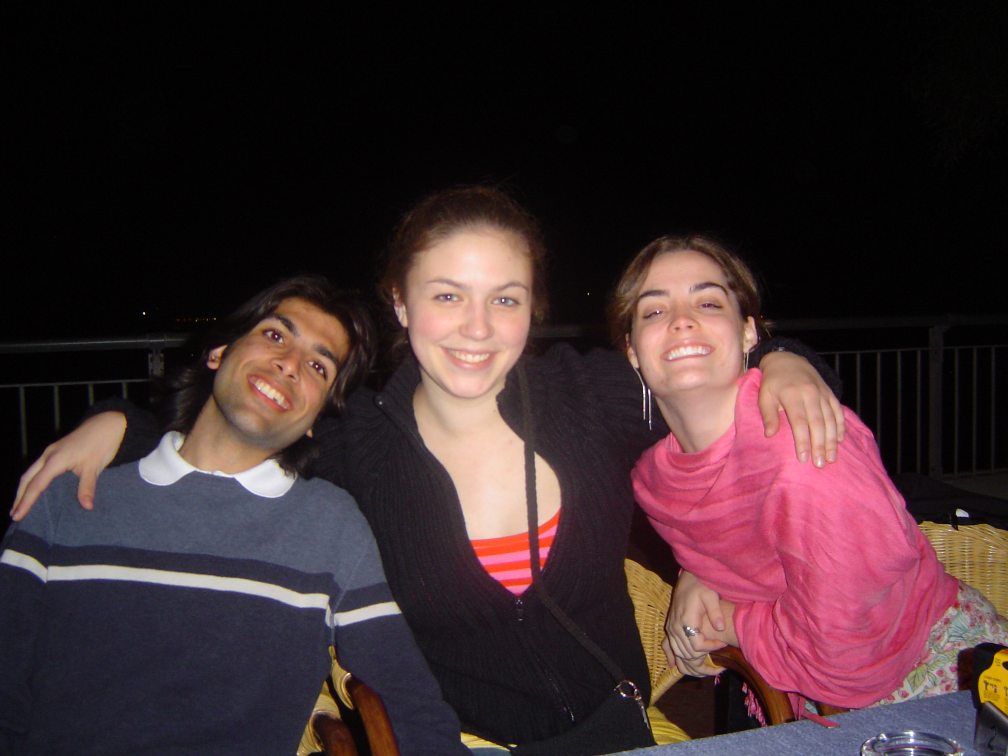 three people posing for the camera at night