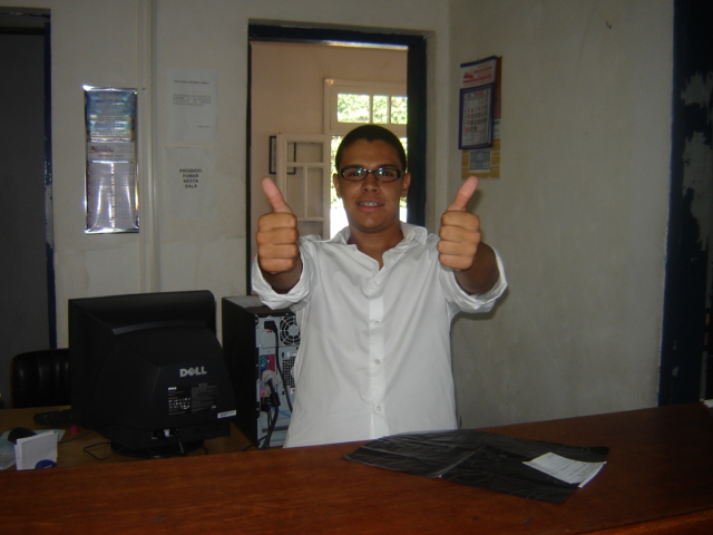 a man shows off his thumbs up on the desk