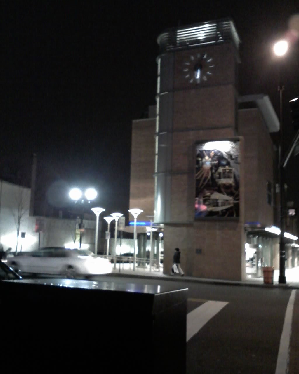 a car stopped in front of a clock tower
