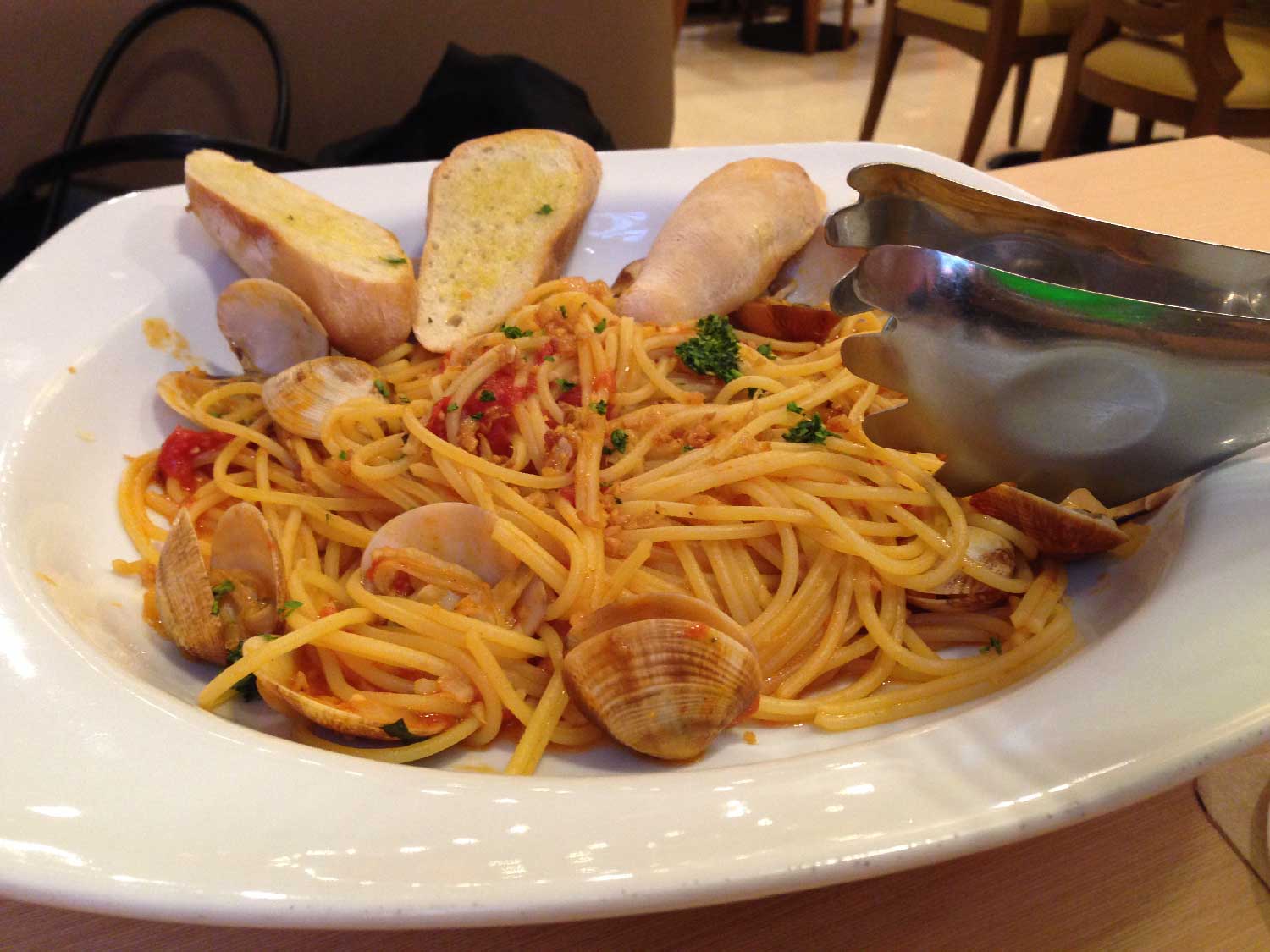 a plate full of pasta and meats on a table