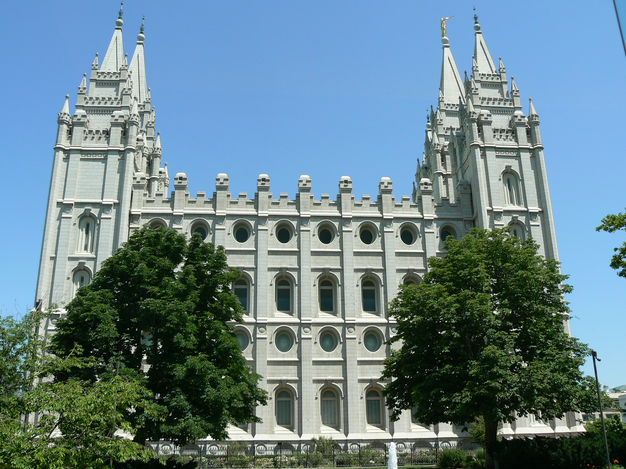 an old building is shown with several trees