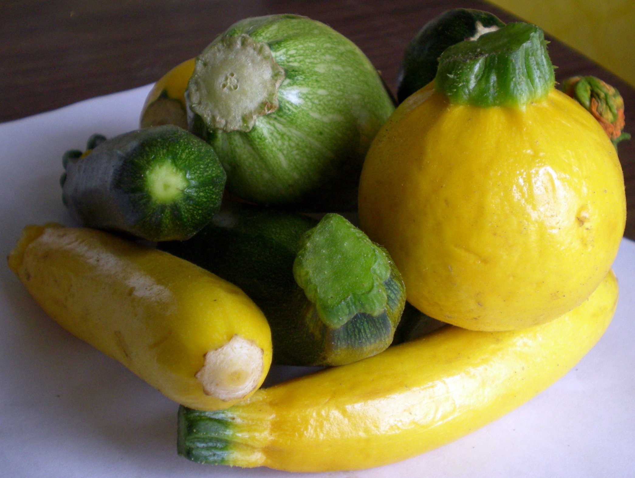 a yellow cucumber and some other fruit are together