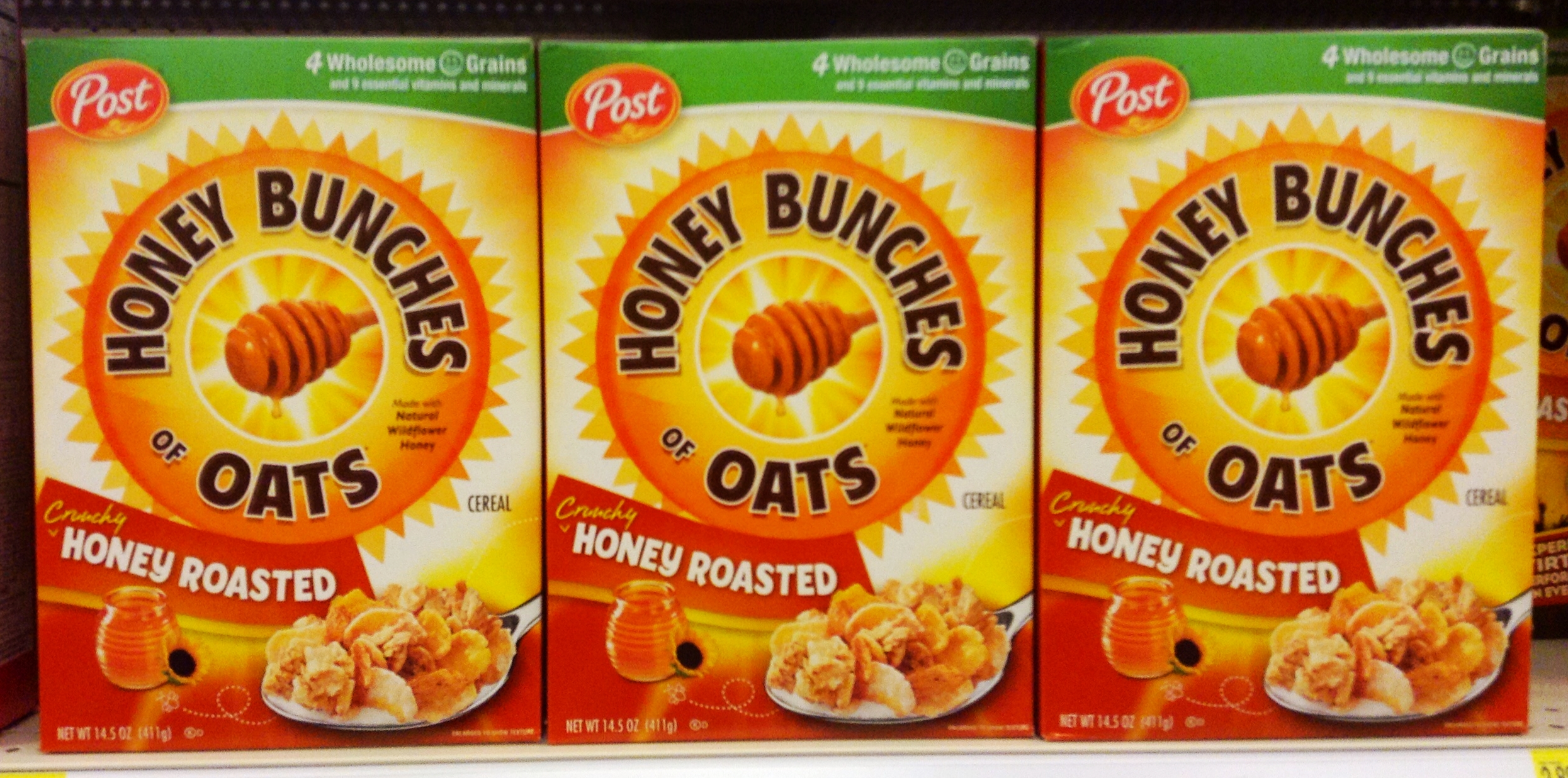 three boxes of honey bunches oats are in the store