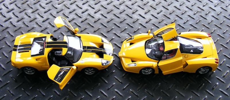 three little toy cars are sitting on a floor