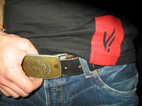 there is a man with the belt that is attached to his jeans