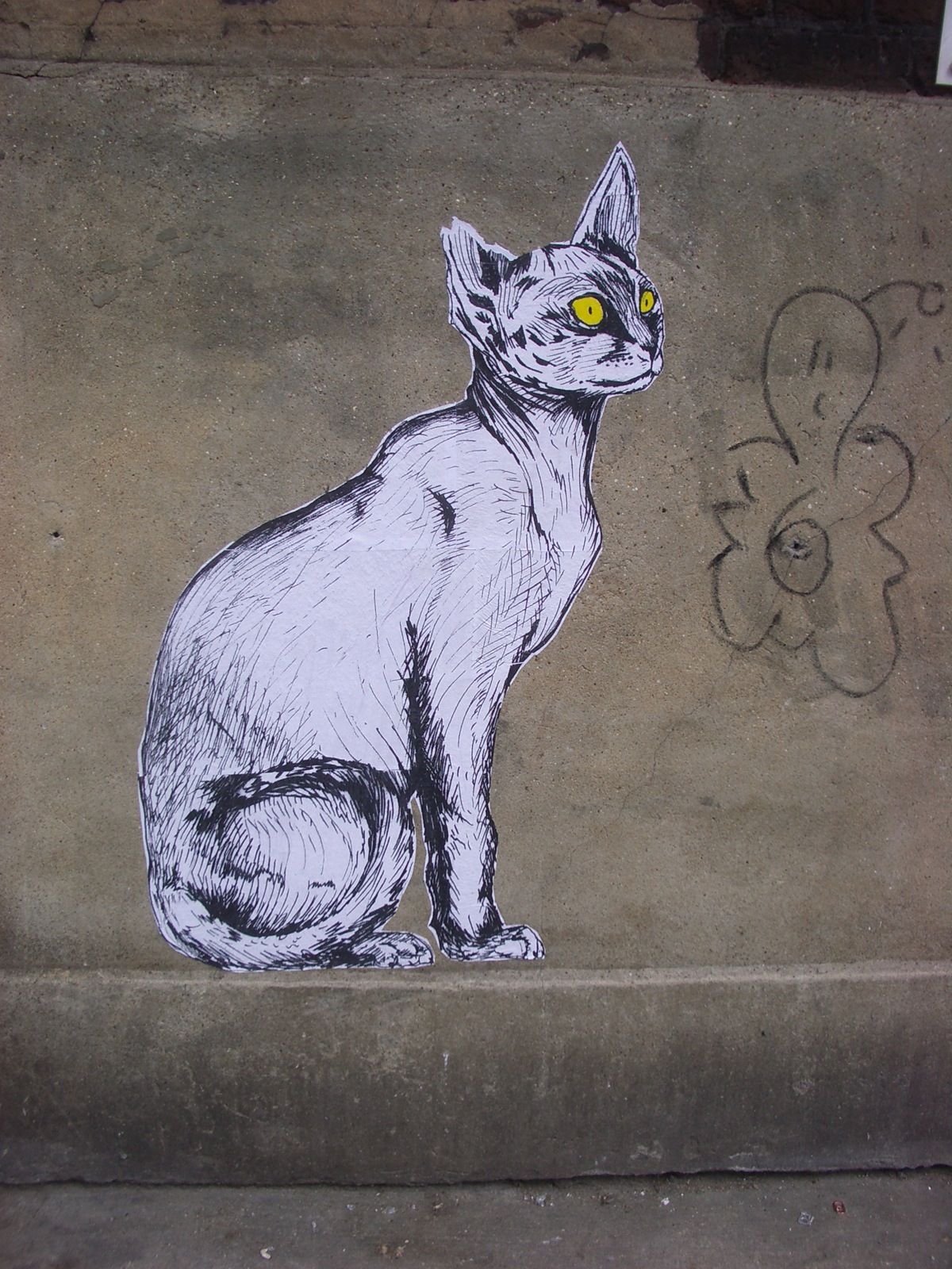 an intricate drawing of a cat painted on the side of a wall