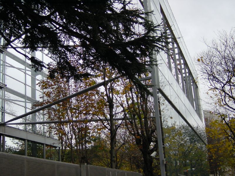a large silver structure with many trees around