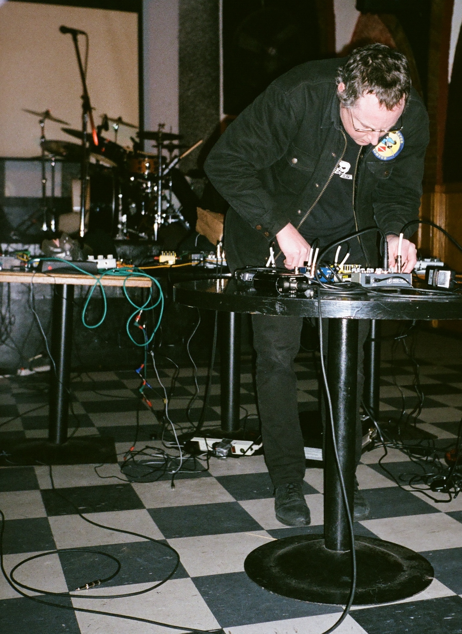 a man standing behind a sound board and microphone