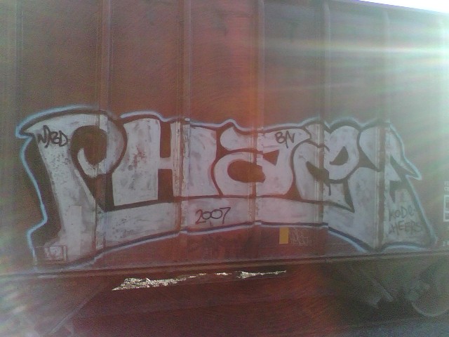 there is graffiti on the side of a train car
