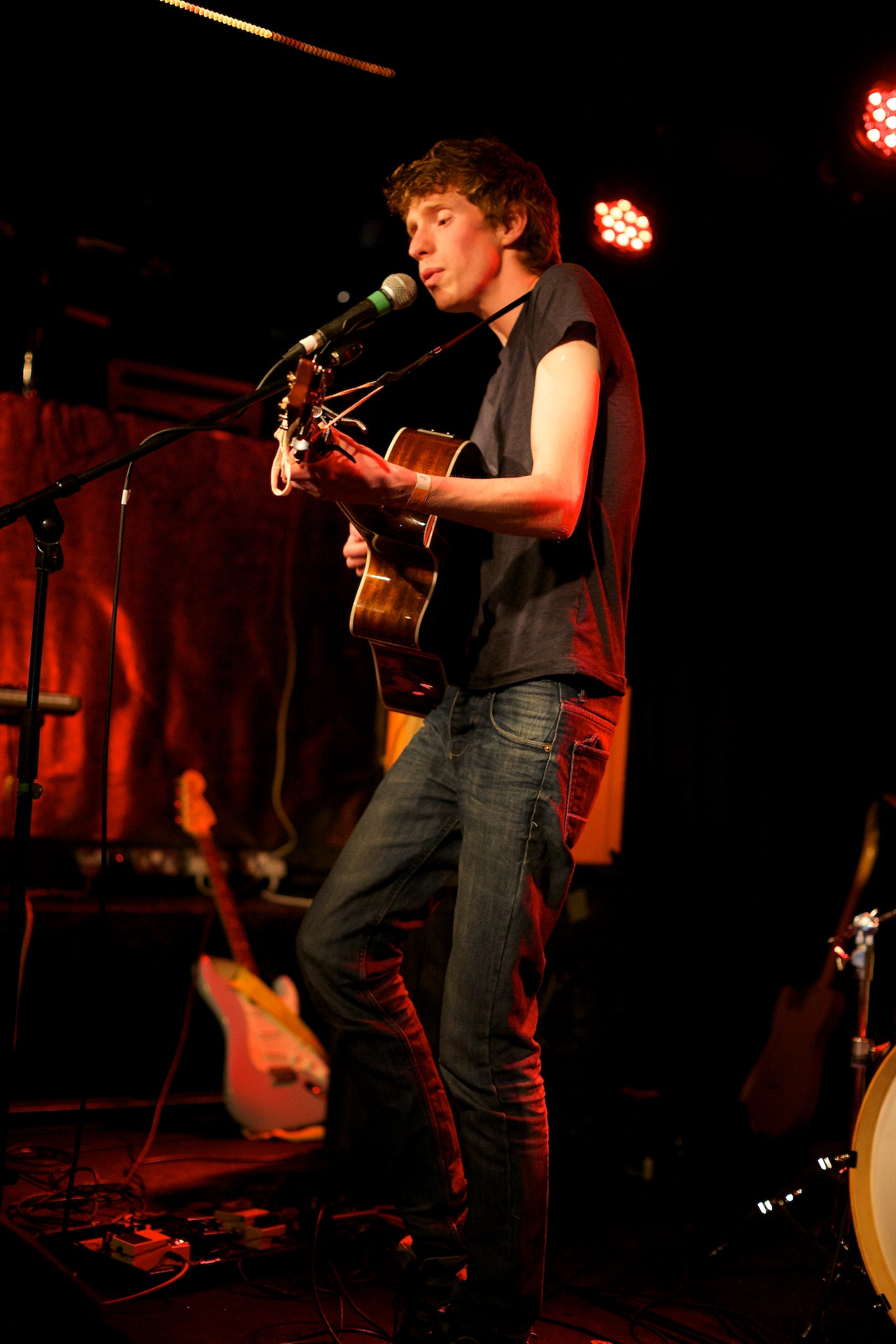 the person on stage with an acoustic guitar