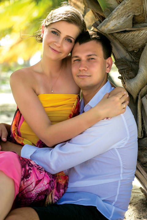 a beautiful young blonde woman wearing a yellow dress holding a man