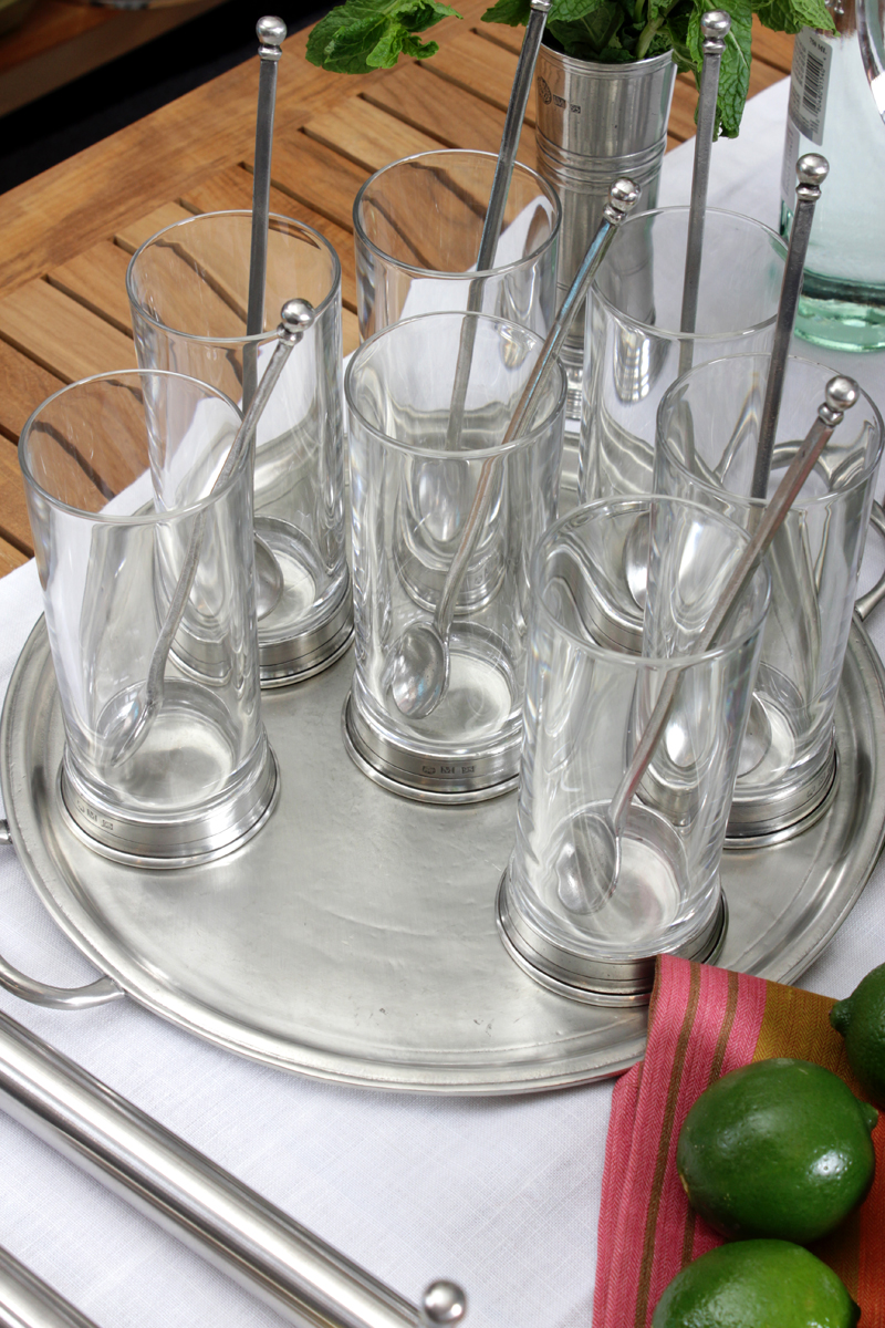 several glasses with spoons and forks on a silver tray