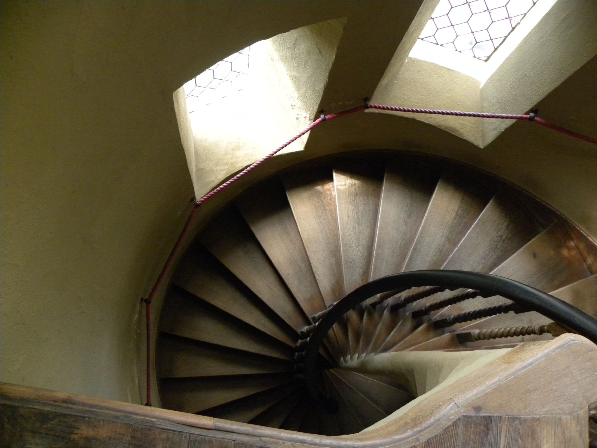 a spiral staircase leads into the light coming in