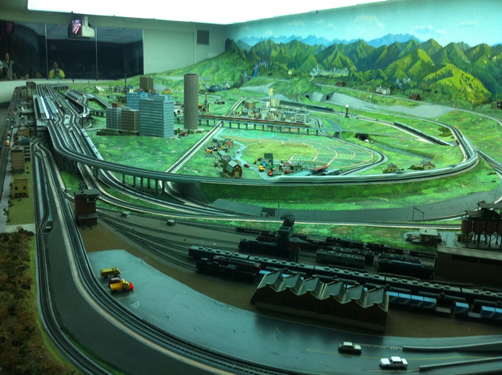 a view of model train tracks with trains coming down the track