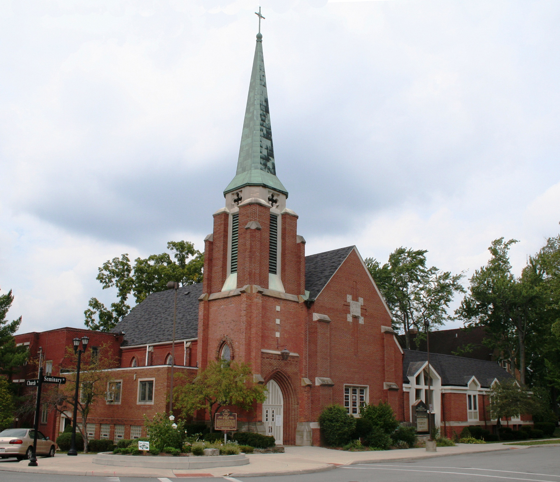 a church with a tall steeple and steeple clock on the front