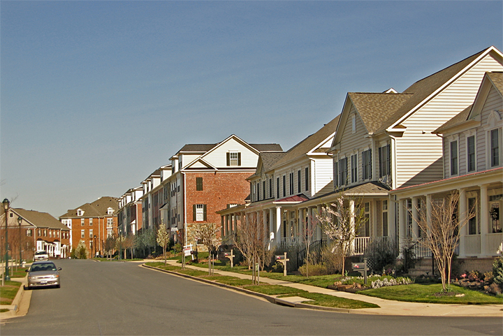 a street lined with row houses on either side of a road