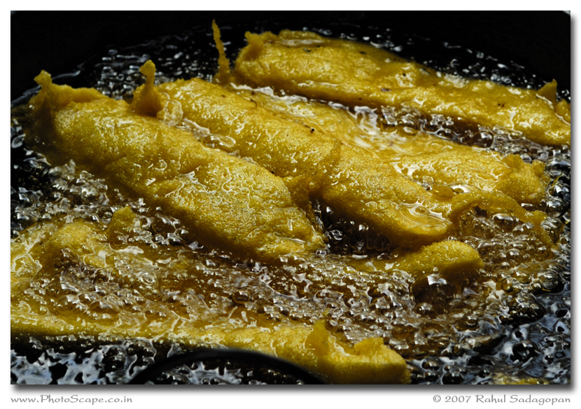 fried food being cooked on a pan with oil