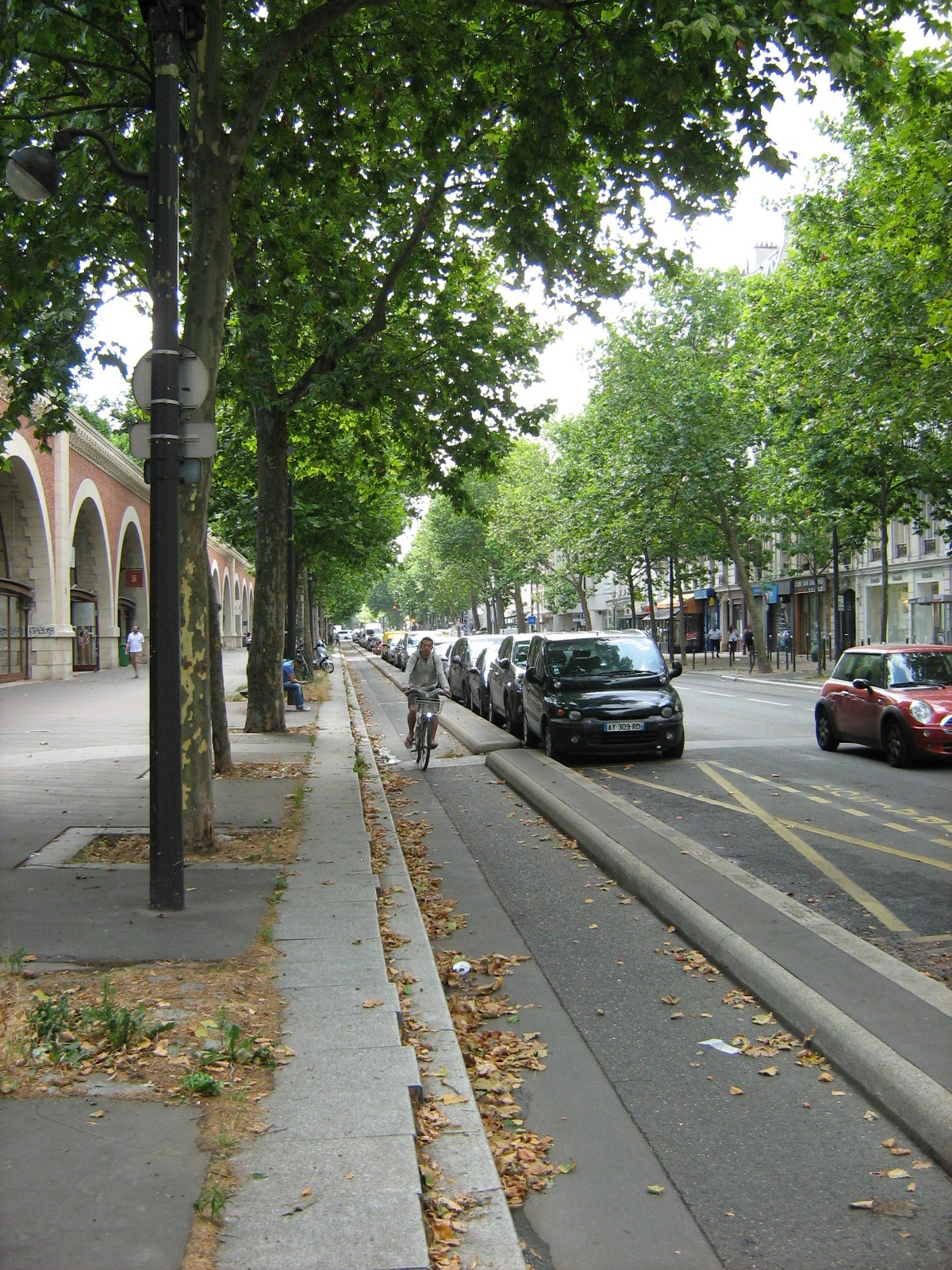 a street with cars and a bike parked next to the street