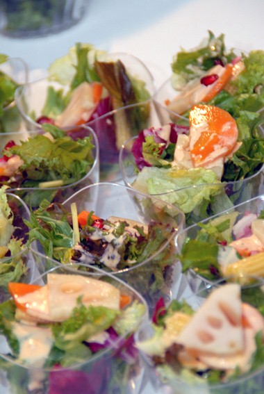 a salad in a small display bowl with many toppings